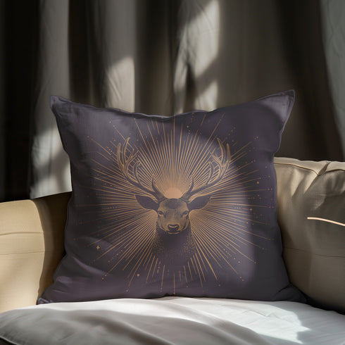 A pillow cover showing a noble stag rendered in shimmering beige against navy blue fabric. Fine beige tan rays extend from the deer's head like sunbeams, with scattered stars.
